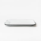 White enamel tray with black edge and handles on a white background