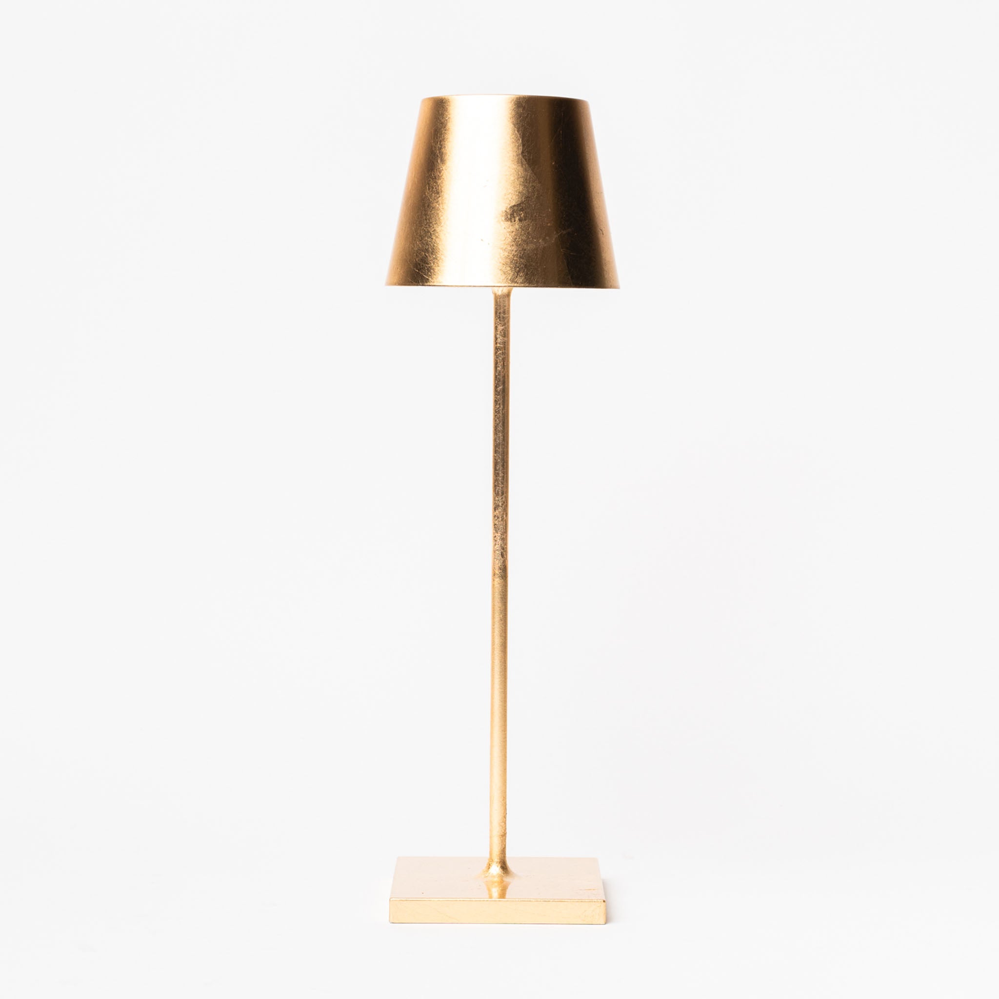 Poldina Pro Table Lamp in Gold Leaf on a white background