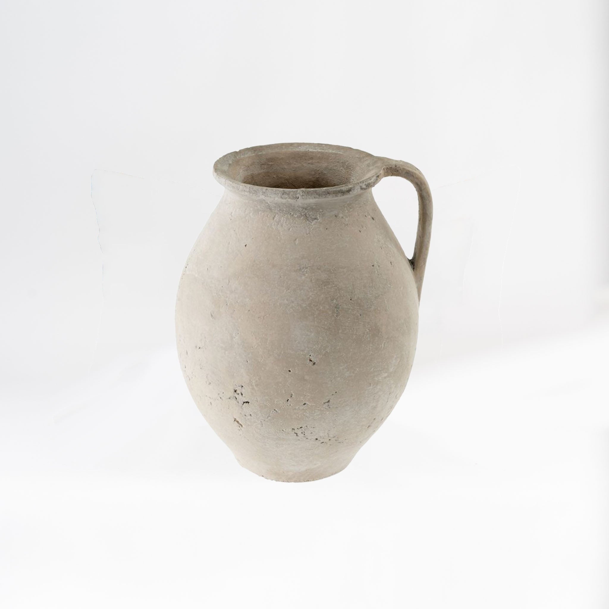 White terracotta urn with handle on a white background