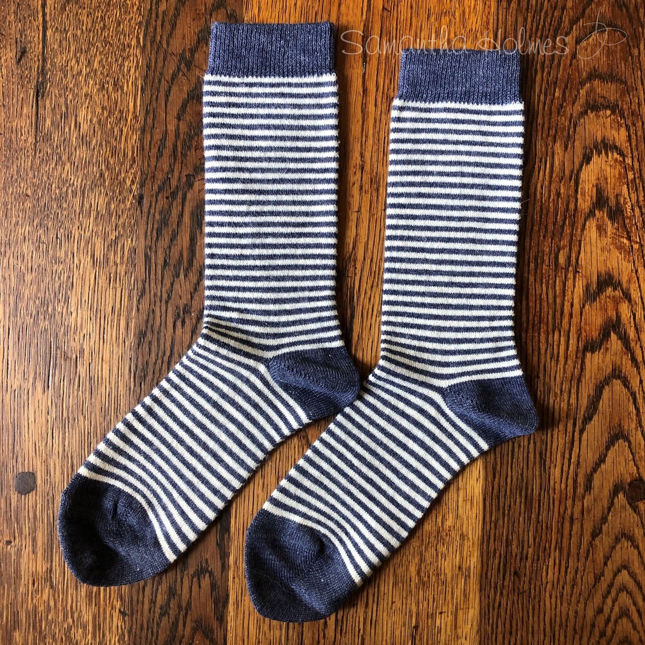 Dark Blue alpaca striped socks on a wood surface