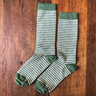 Green alpaca striped socks on a wood surface