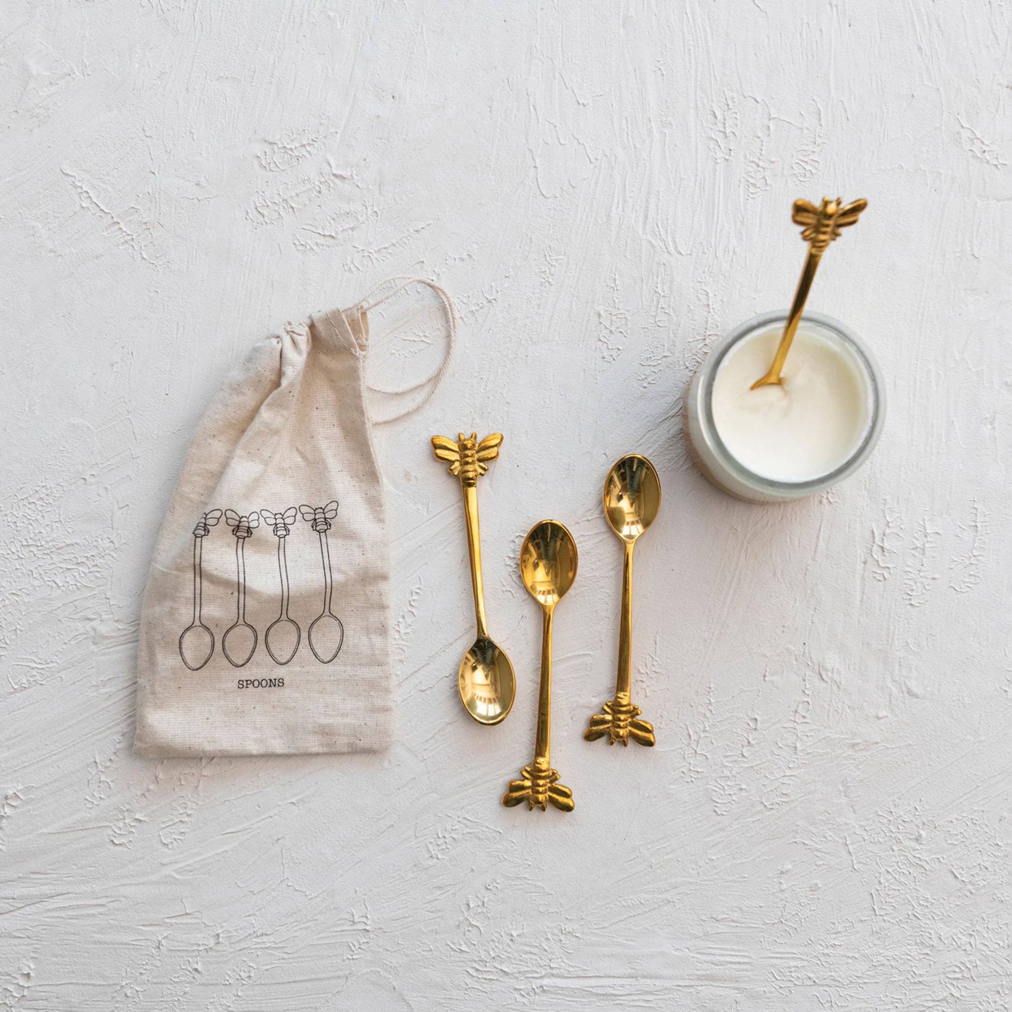 Bee Brass Spoons on a white background