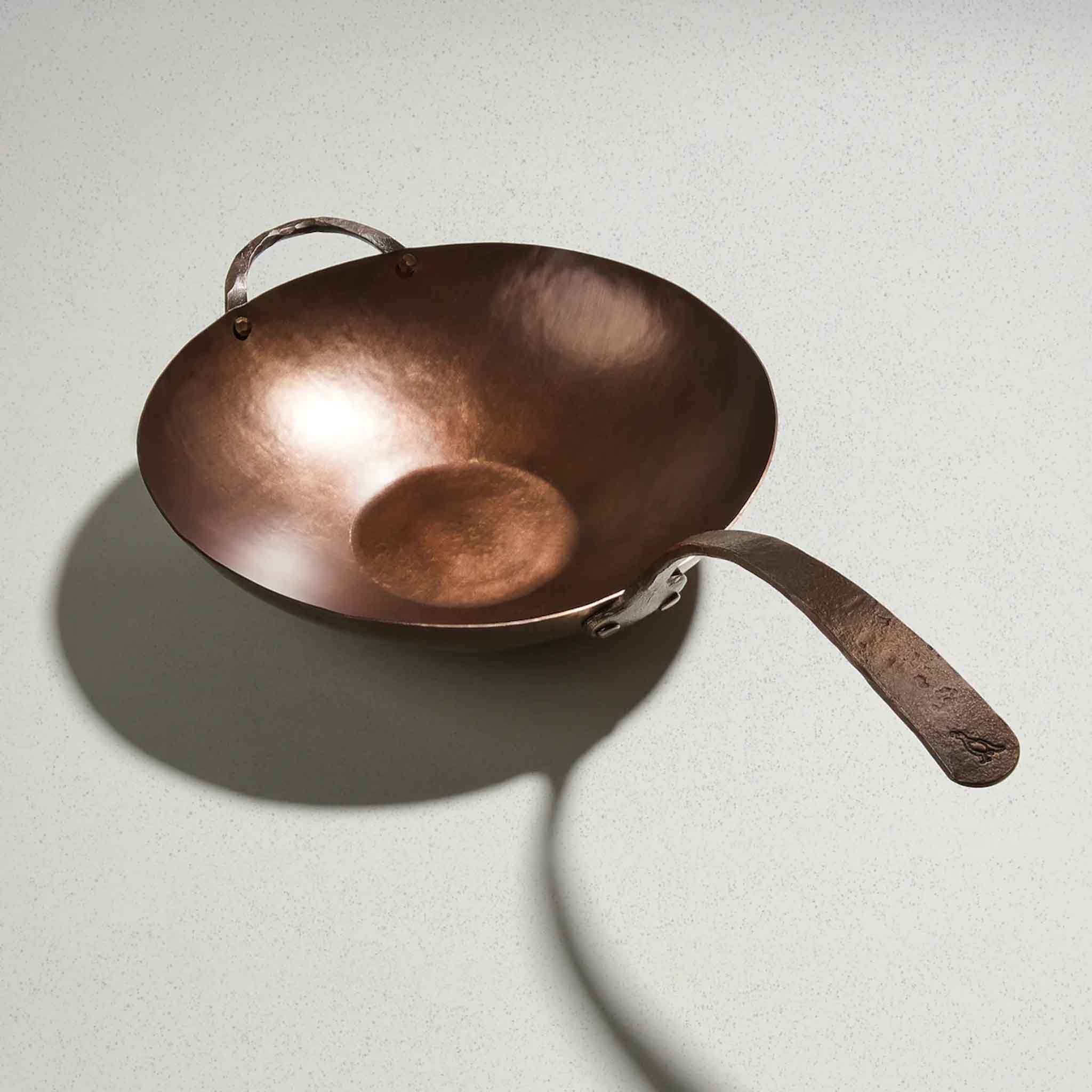 Smithey Carbon Steel Wok on a grey surface