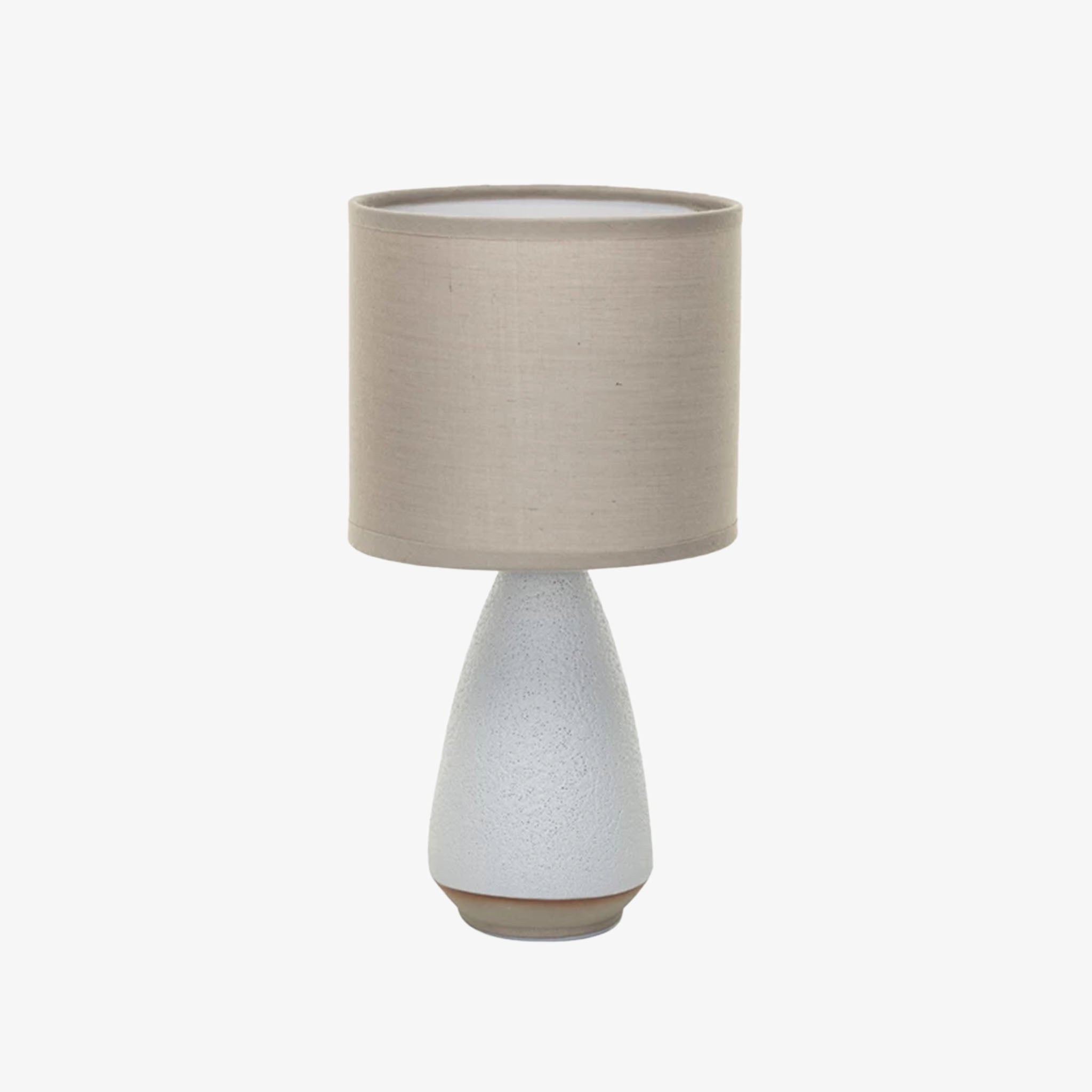 Small white stoneware light with linen shade on a white background