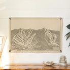 Sugarbush Ski Trail Felt Banner hanging on a white wall over a wood table with decorative items