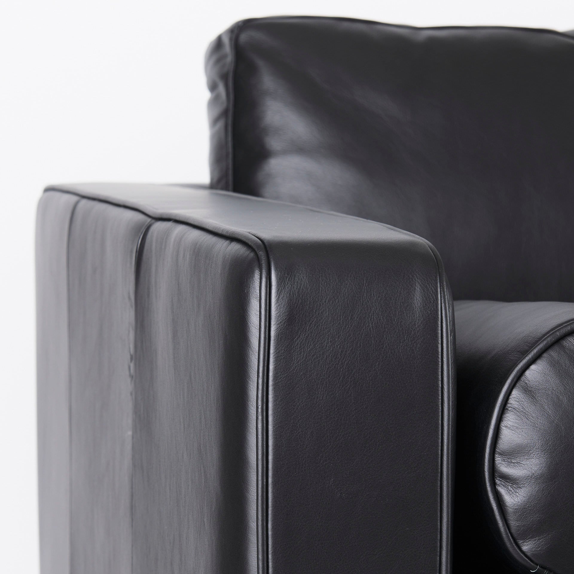 Close up of Svend Black Leather Sofa on a white background