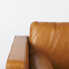 Svend Tan Leather Love Seat Sofa on a white background