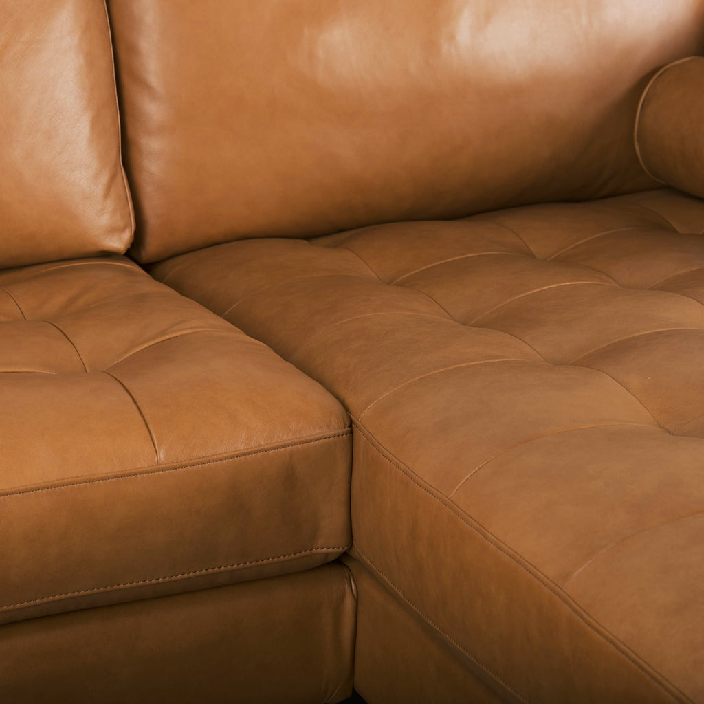 Close up of Svend Tan Leather Right Chaise Sectional Sofa on a white background