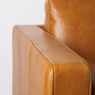 Close up of Svend Tan Leather Sofa on a white background