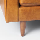 Close up of Svend Tan Leather Sofa on a white background