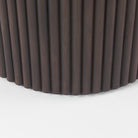 Close up of Terra Dark Brown Wood Round Fluted Dining Table on a white background