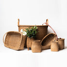 Collection of hand made in vermont rattan baskets on a white background