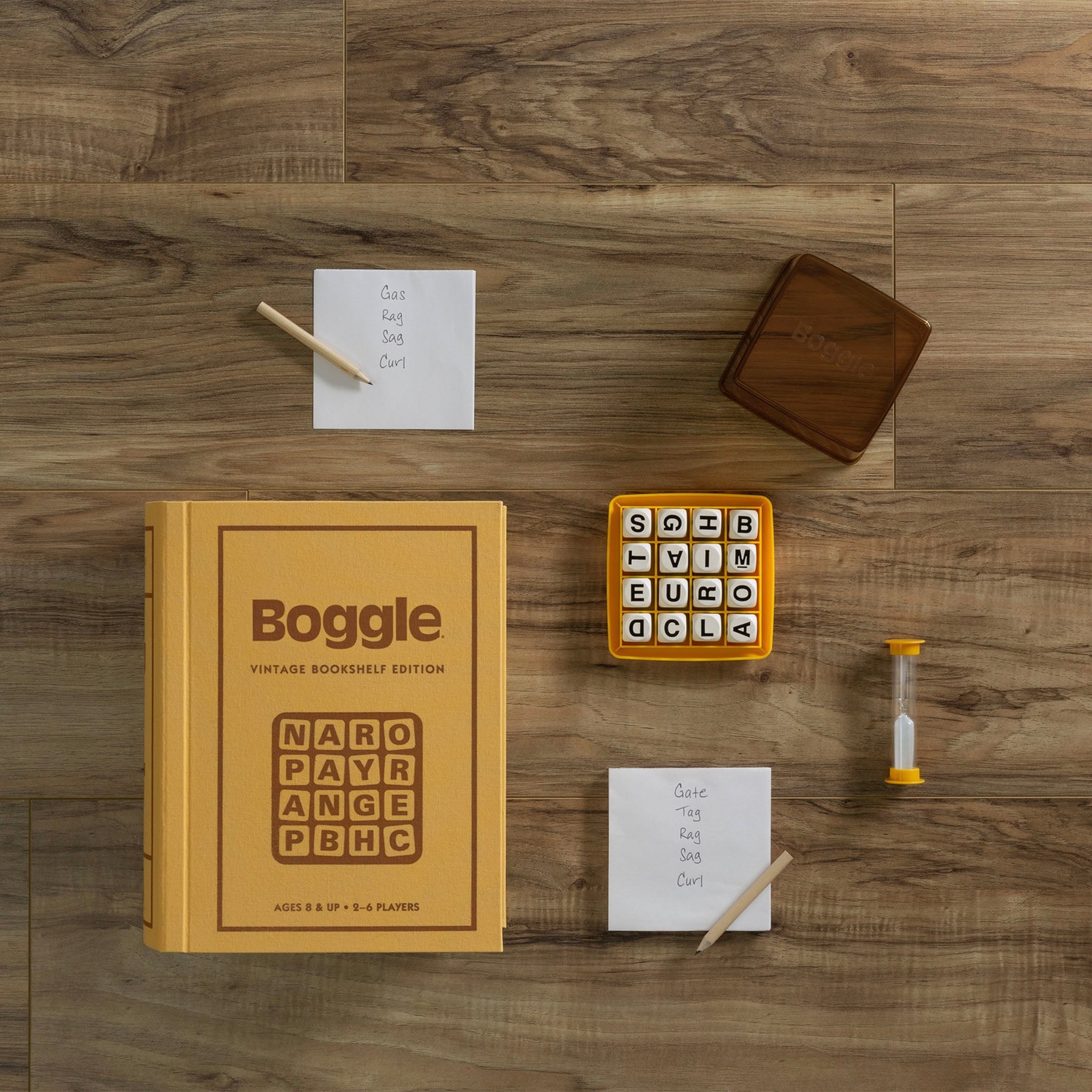 Vintage Bookshelf Edition Boggle on a wood table displaying the game components 