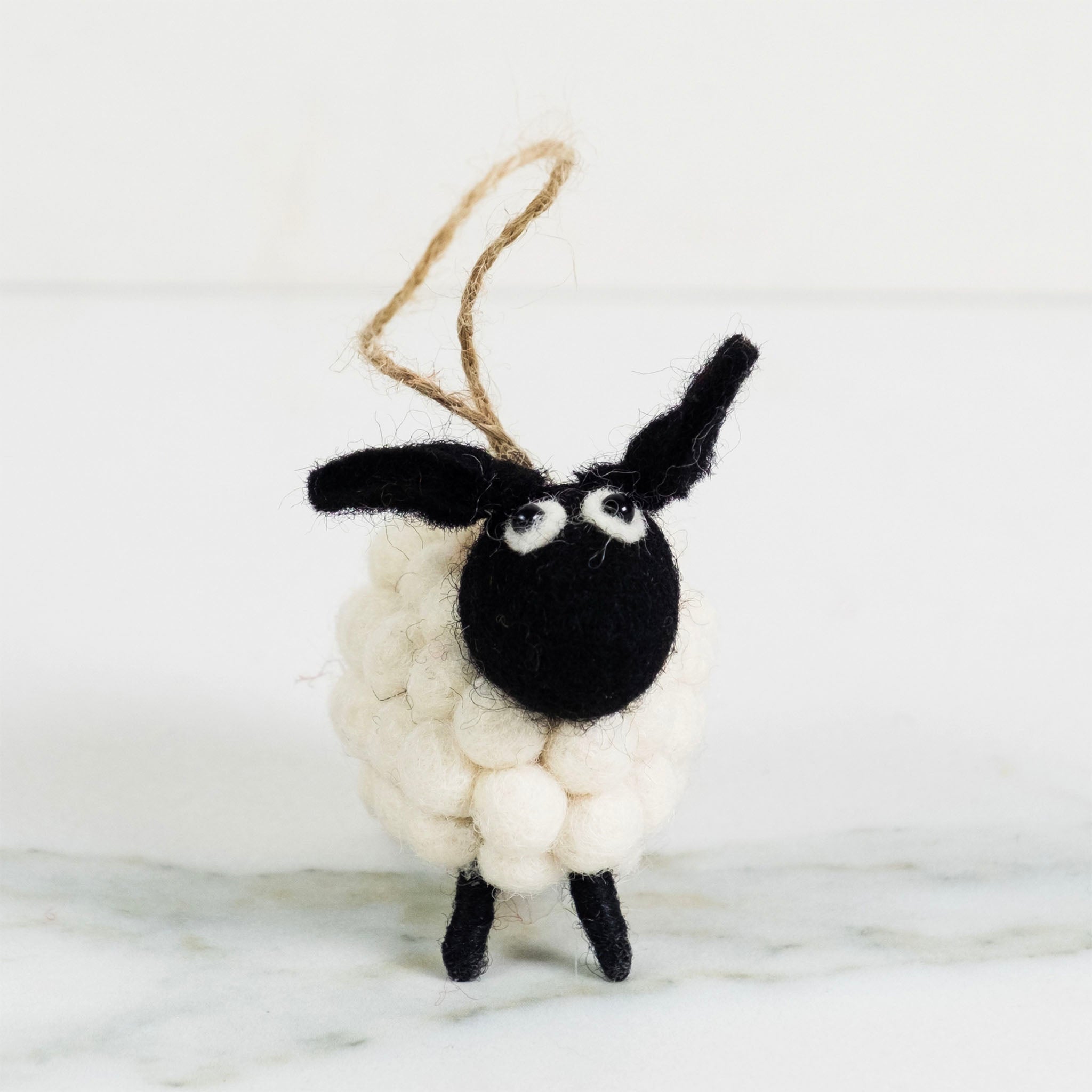 White Ball Sheep Felt Ornament on a white backgroudnd