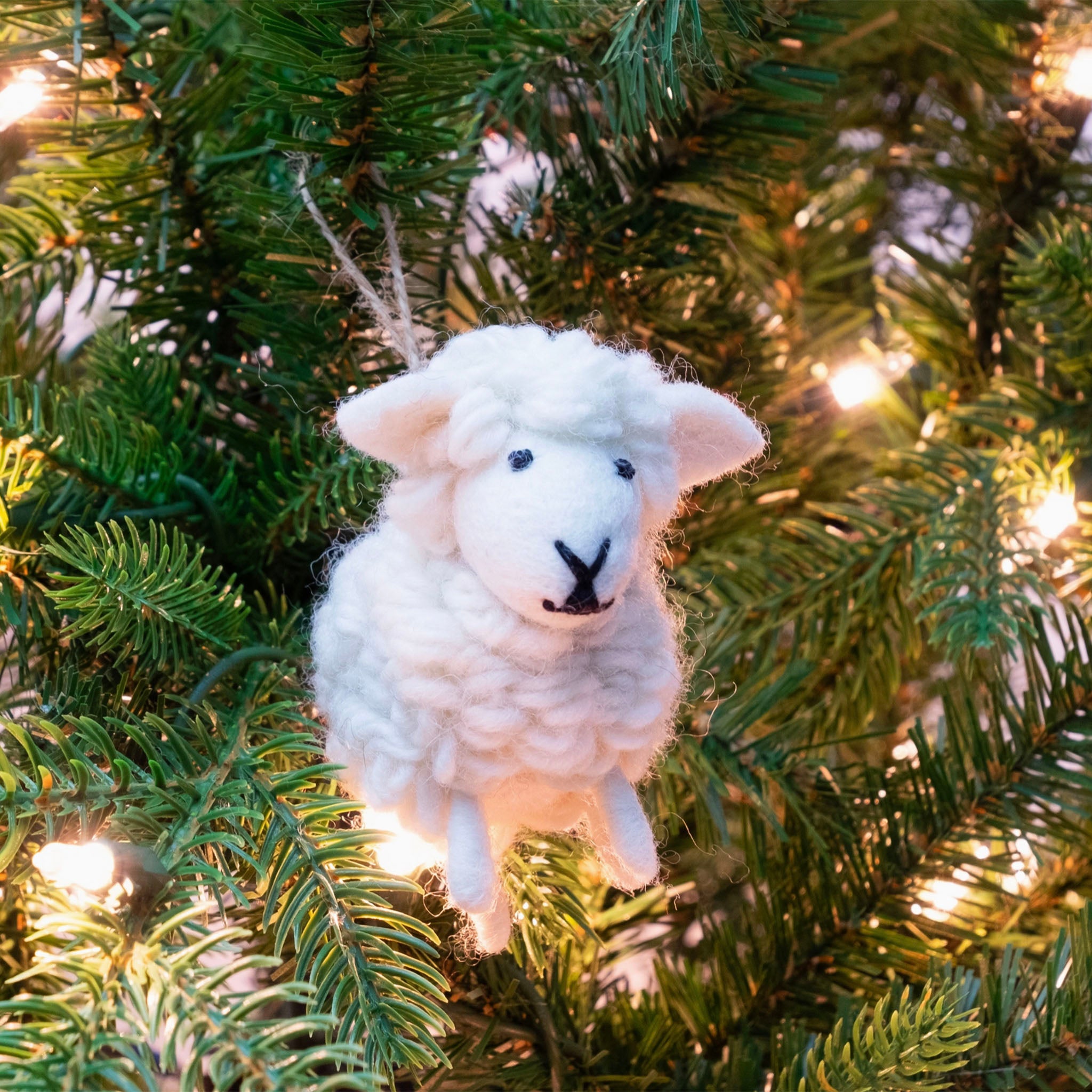 White Sheep Felt Ornament hanging on a christmas tree 