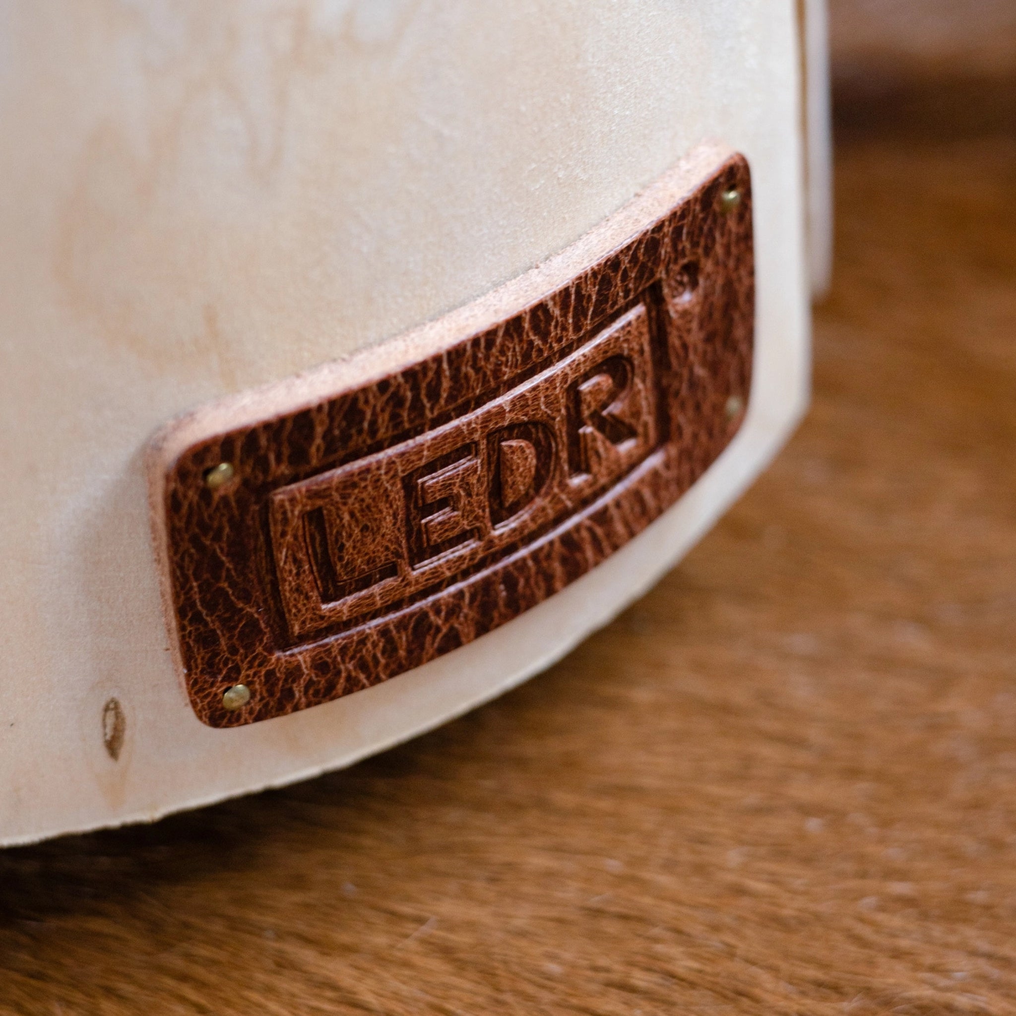 Close up of Large Cherry Trunk Light with Leather Strap on a table at Addison West