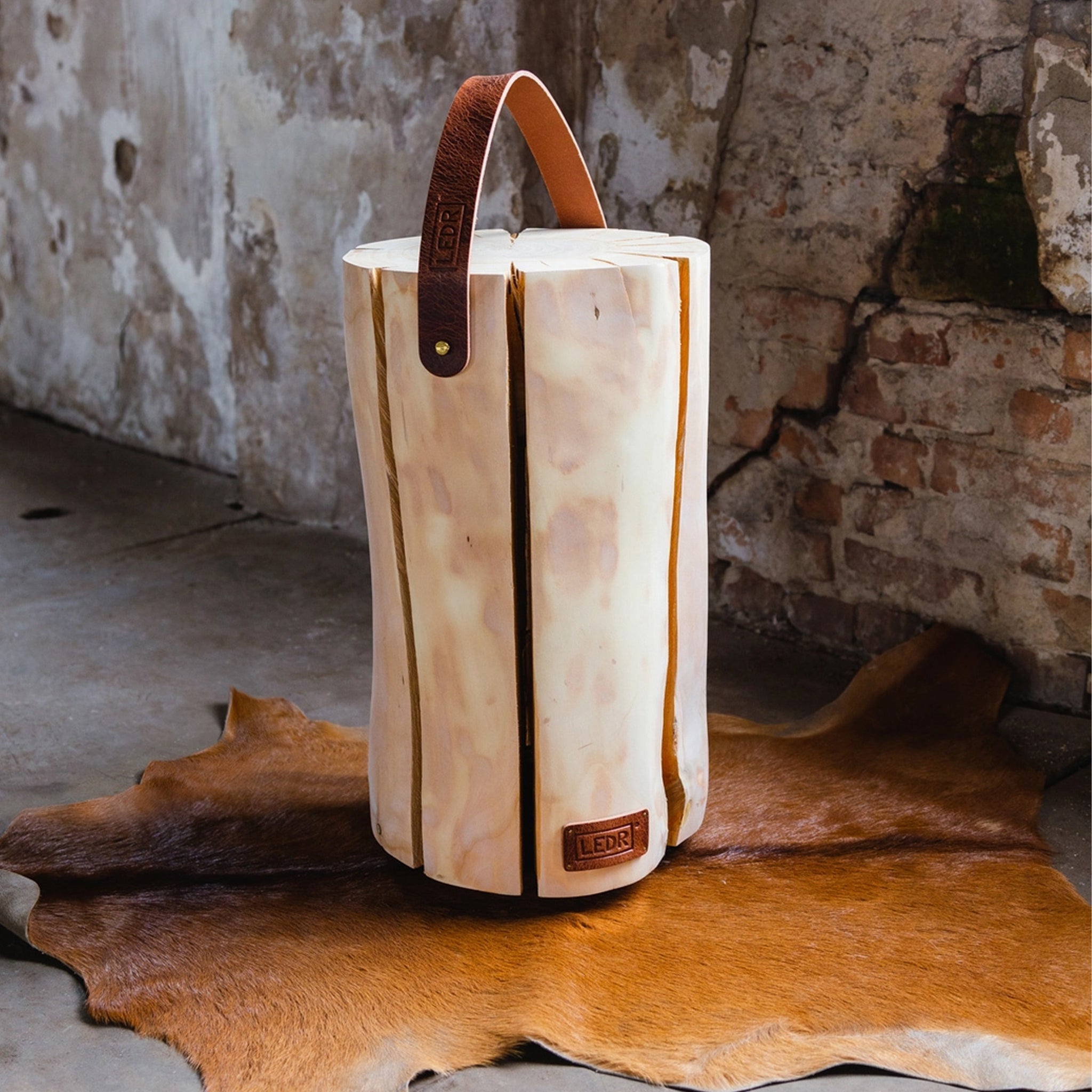 Large Cherry Trunk Light with Leather Strap on a hide rug at Addison West