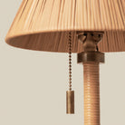 Close up of Woven Delphine Mini Table Lamp on a beige background at Addison West