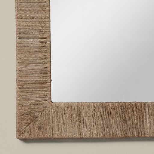 Close up of Highball Jute Rectangular Mirror on a beige background