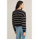 Model wearing Z Supply Estero Stripe Sweater Eclipse with light blue jeans in front of a neutral backdrop