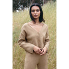 Model wearing Z Supply Modern Estelle Cardigan in Oatmeal Heather in front of a grassy slope