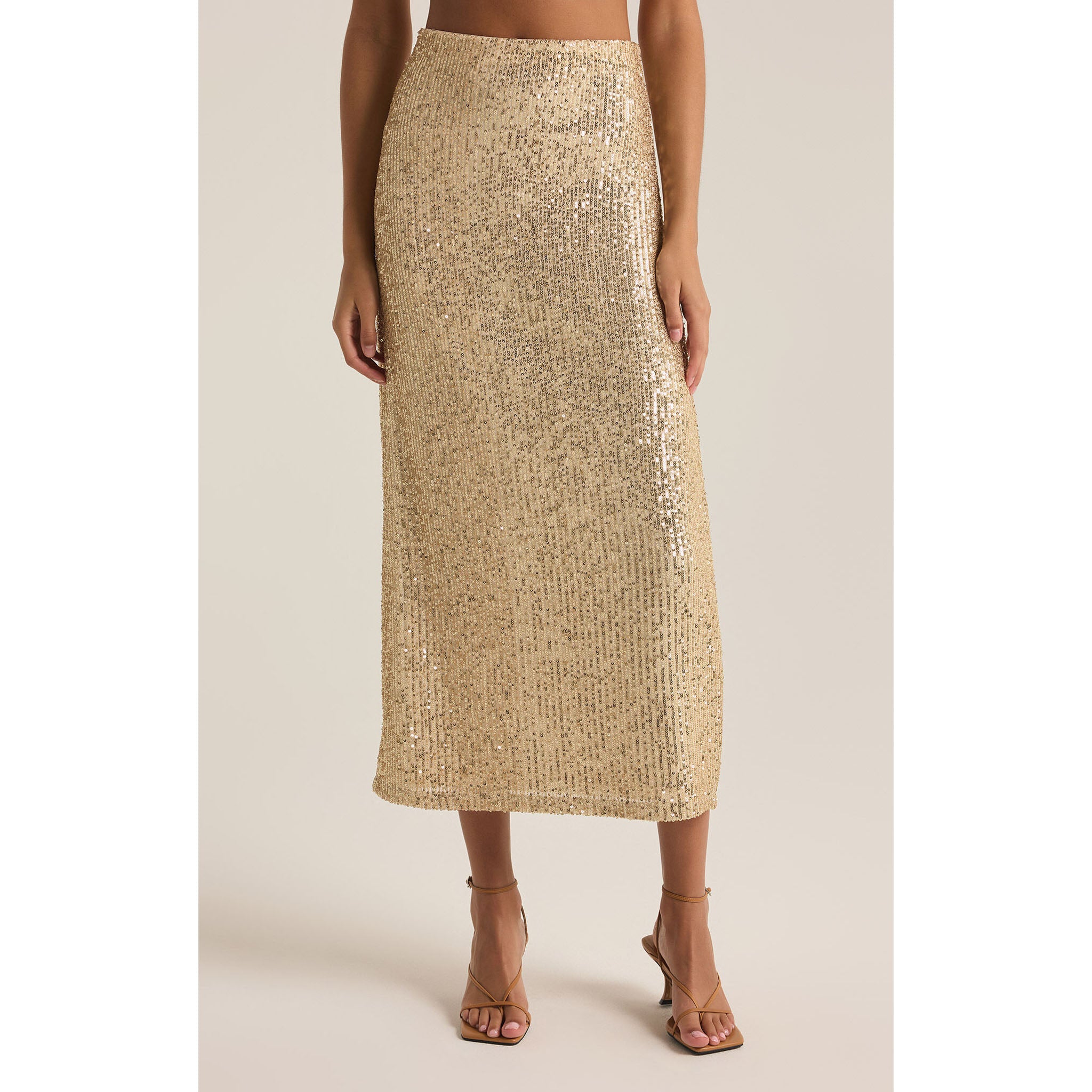 Model wearing Z Supply Saturn Sequin Skirt in Champagne in front of a neutral backdrop