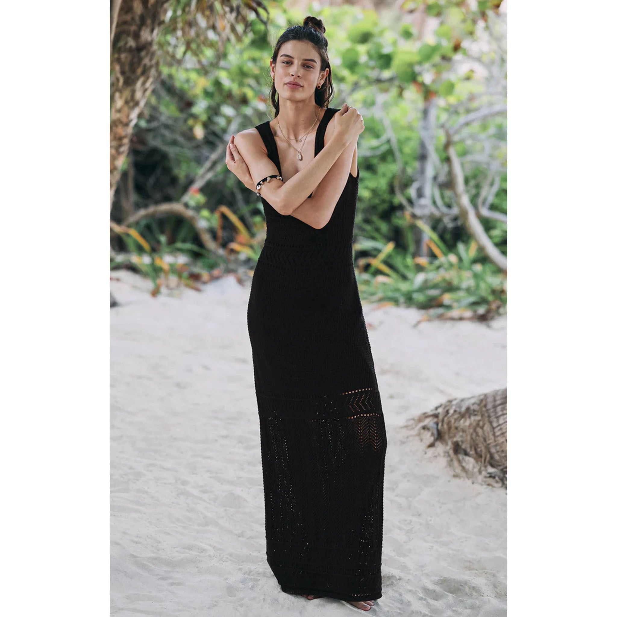 Model wearing Z Supply Tarelle Maxi Dress in Black standing in sand in front of tropical trees