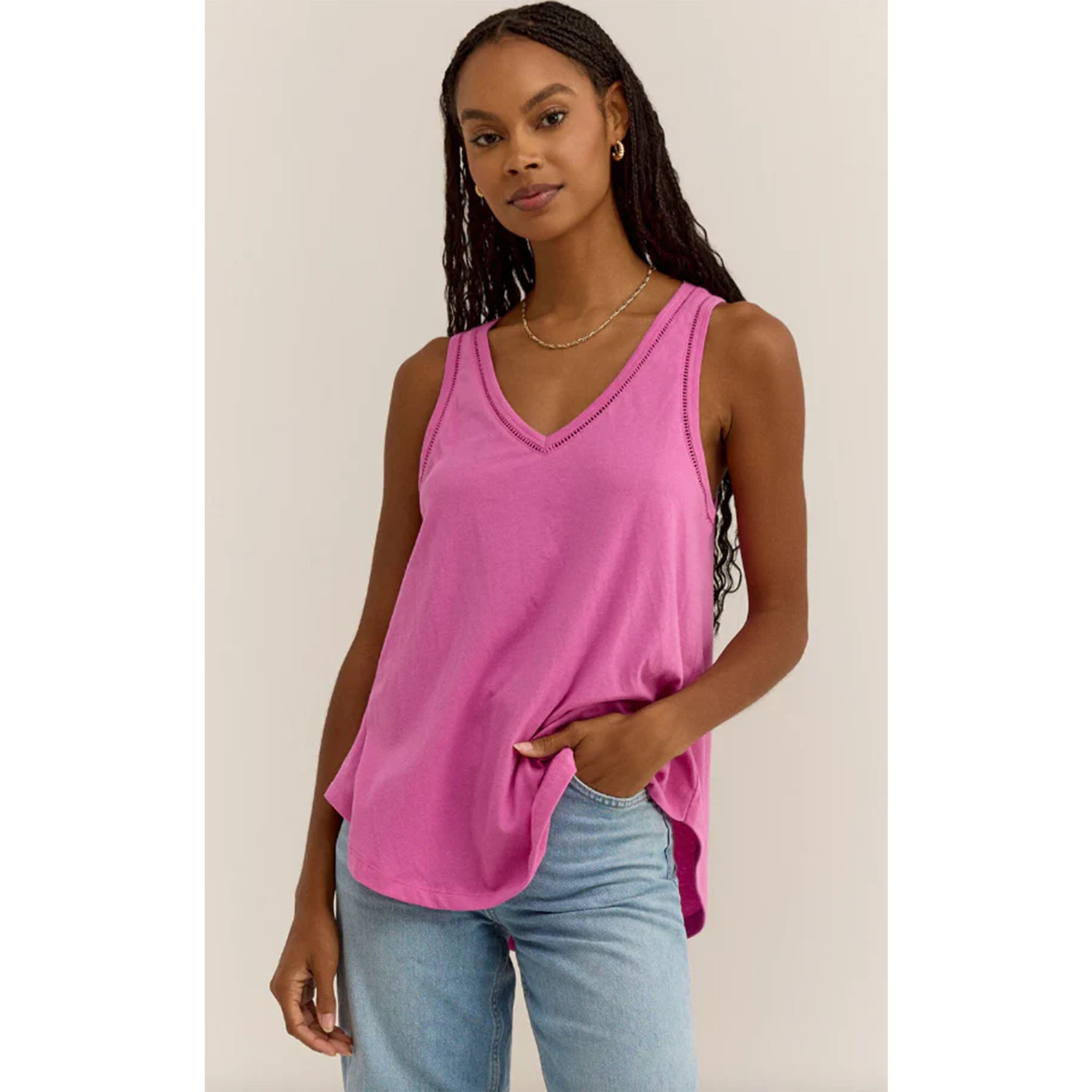 Model wearing Z Supply Vagabond Lace Trim Tank in Raspberry Sorbet in front of a beige background