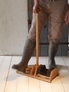 Person taking boots off with Boot Scraper + Bootjack Stand at Addison West