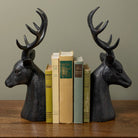 Stag Bookends with books on a wood table at Addison West.