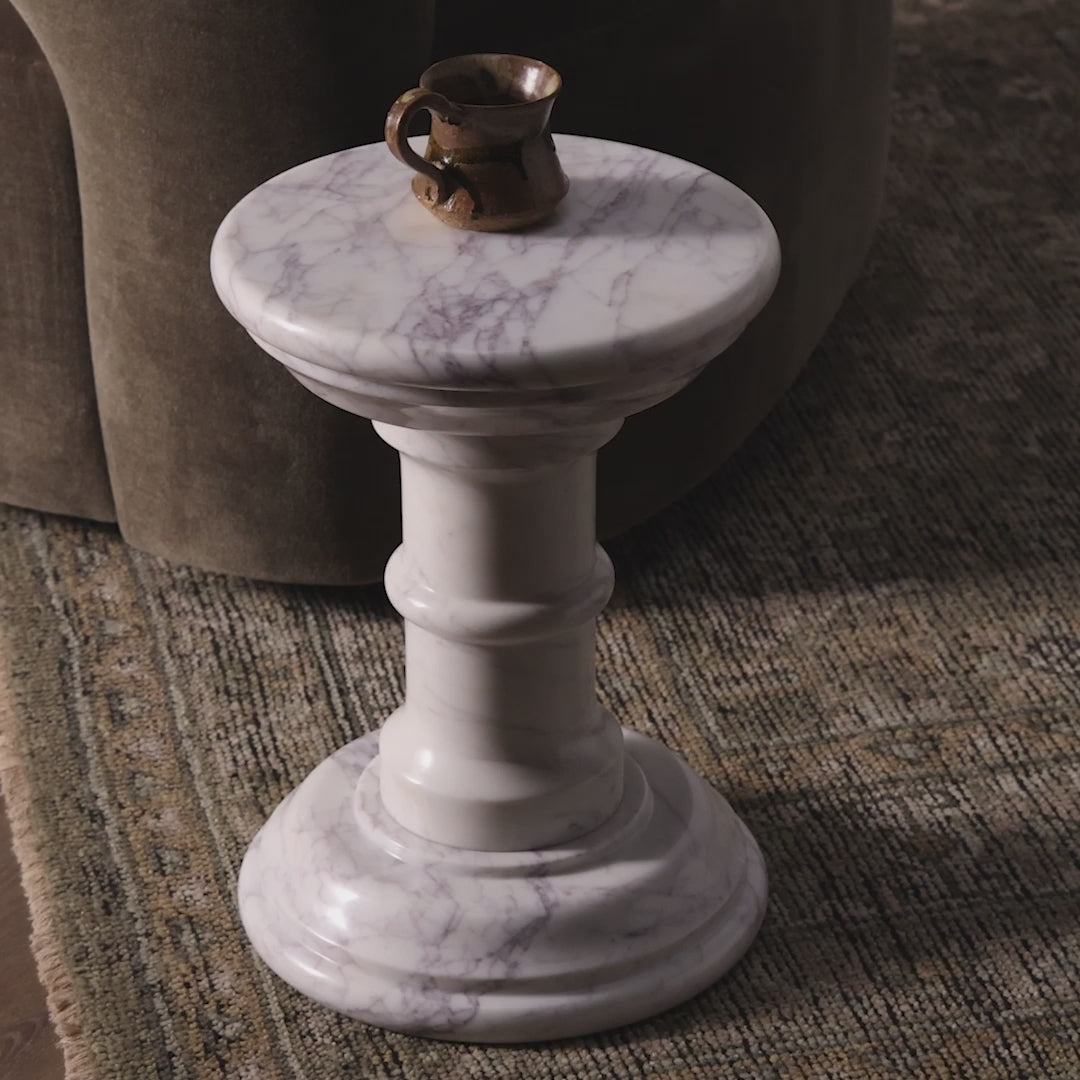 Four Hands Cyprus End Table in Veined White Marble Solid in a modern living room with a mug on top