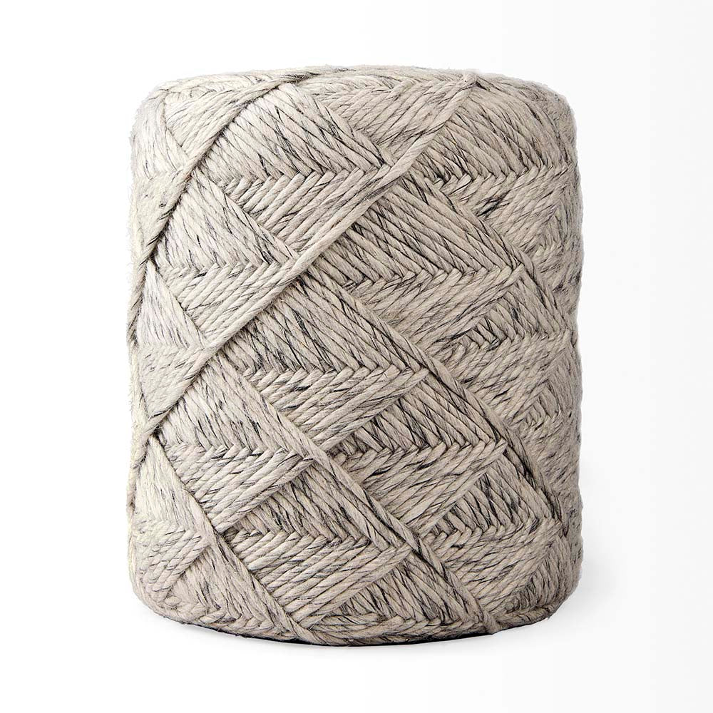 Round pouf covered in woven grey wool in a lattice chevron pattern on a white backrgound