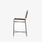 Four hands brand wharton counter stool with black iron frame and dark brown leather seat on a white background