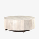 'Hudson' round coffee table by four hands furniture in light wood Ashen walnut color with dark wood legs on a white background