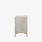 Side view of Whitewashed nightstand with drawer and marble top on a white background