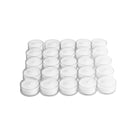 small white tea candles in glass containers on a white background