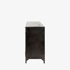 Small black metal cabinet with glass doors and cross hatch mullion design on a white background