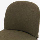 Four Hands Brand Astrud dining chair with boucle olive fabric seat and back and iron legs on a white background