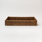 Rattan rectangular tray with two cut out hands on white background