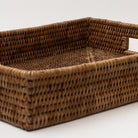 Rattan rectangular tray with two cut out hands on white background