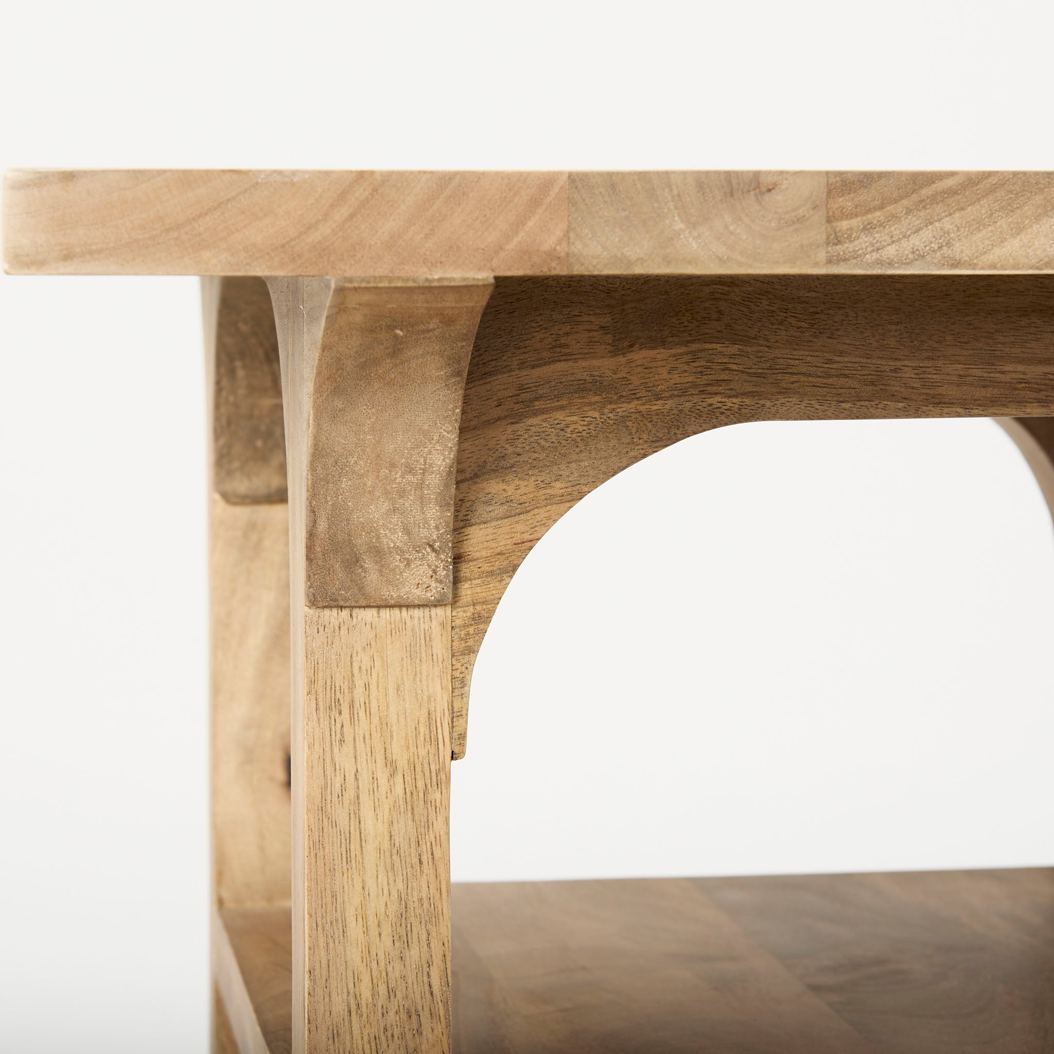 Light wood accent table with arched base and shelf detail on a white background