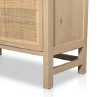 Close up of wood legs on Four hands furniture brand caprice book case with light wood and rattan