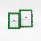 Two green picture frames with bamboo wood style edge on a white background