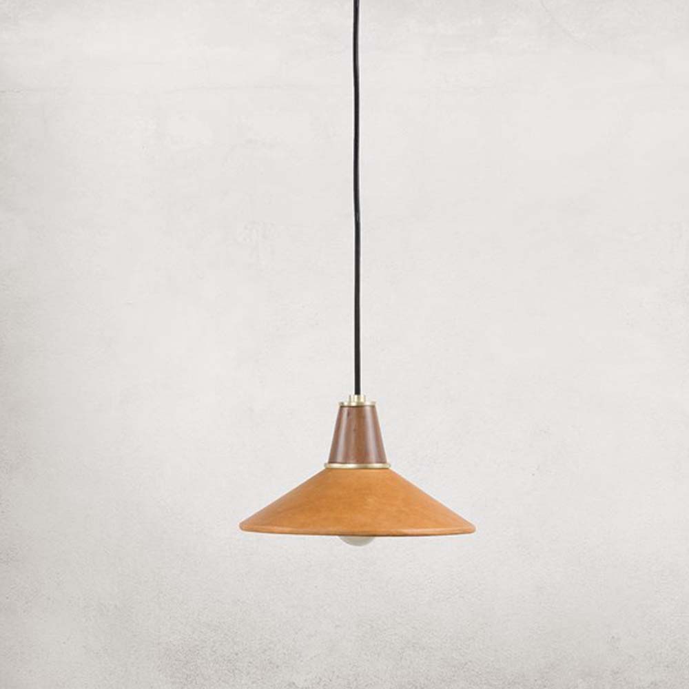 Leather and walnut pendant light with brass accents and black cord on a white background