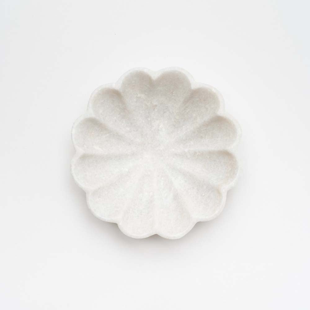 Marble dish shaped like a flower on a white background