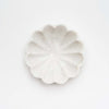 Marble dish shaped like a flower on a white background