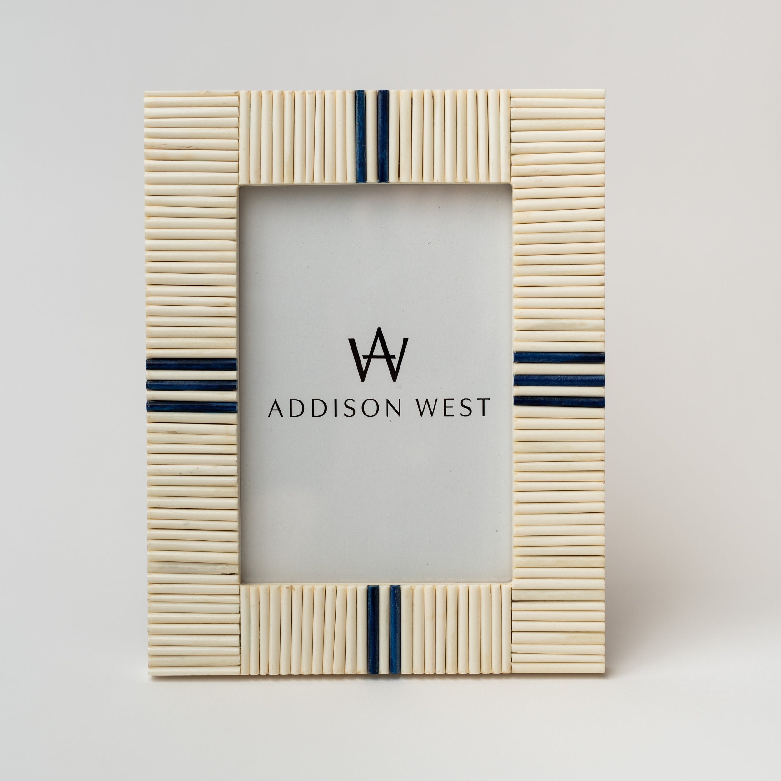 Picture frame with white bone inlay and navy blue accents on a white background