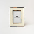 White picture frame with brown bone edges on a white background 