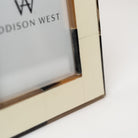 Close up of bone inlay on white picture frame