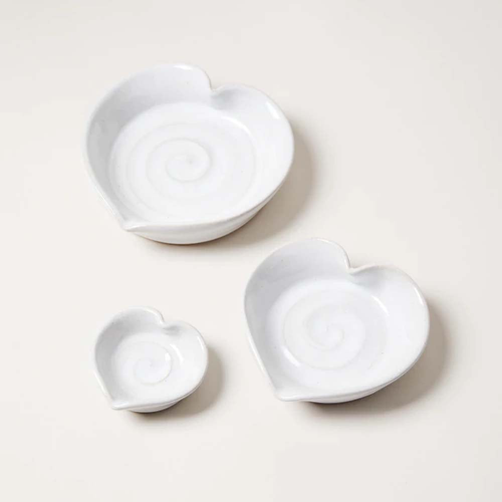 Farmhouse pottery heart dish set of three white hearts on a white surface